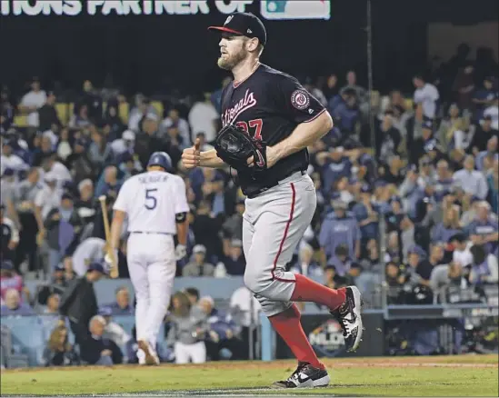  ?? Wally Skalij Los Angeles Times ?? NATIONALS pitcher Stephen Strasburg leaves the field after striking out Corey Seager and the side in the fifth inning. Strasburg finished with 10 strikeouts.