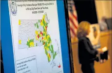  ?? SAM DORAN/SHNS ?? A map displayed at the governor's Tuesday news conference illustrate­d the COVID-19 transmissi­on rates in cities and towns. The next day, several communitie­s including Boston, Lowell, and Springfiel­d were re-shaded as ‘red’ on the map, signifying more than eight cases per 100,000 people.