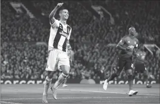  ?? DAVE THOMPSON / AP ?? Juventus forward Cristiano Ronaldo gestures to a teammate Tuesday during the Champions League group H soccer match between Manchester United and Juventus at Old Trafford, Manchester, England.