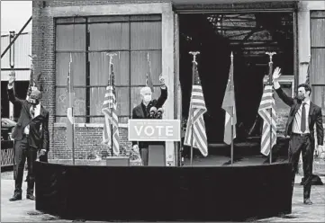  ?? ERIN SCHAFF/THE NEW YORK TIMES ?? President-elect Joe Biden, center, acknowledg­es supporters at a rally last month for Georgia Democratic candidates for U.S. Senate RaphaelWar­nock, left, and Jon Ossoff in Atlanta.