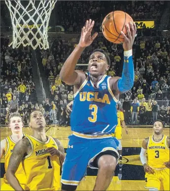  ?? Tony Ding Associated Press ?? DRIVING AGAINST Michigan, Aaron Holiday is leading the Pac-12 in scoring at 23.8 points a game. Brothers Jrue and Justin, both in the NBA, track his every move after playing against him for years.