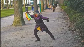  ?? (File Photo/AP/Francisco Seco) ?? A woman wields a sword Jan. 26 as she practices Tai Chi at the Cinquanten­aire park in Brussels.