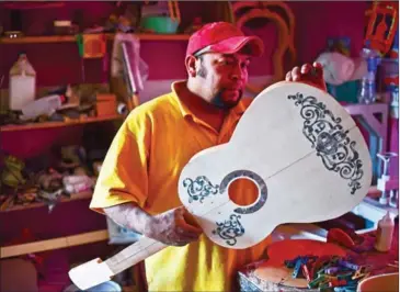  ??  ?? Mexican luthier Salvador Meza makes a replica guitar from Michoacan state, Mexico, on January 9. the movie at his workshop, in Paracho,