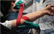  ?? New York Times file photo ?? A pop-up blood drive collects donations at T-Mobile Park in Seattle. The FDA plans to revise a policy that excluded most gay men from donating blood.