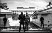  ?? CARL COURT/GETTY ?? South Korean soldiers stand guard Wednesday at the border village of Panmunjom in the Demilitari­zed Zone.