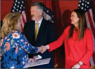  ?? (Arkansas Democrat-Gazette/Thomas Metthe) ?? Gov. Sarah Huckabee Sanders (right) shakes hands with Susan Gatto, director of the School of Nursing at University of Central Arkansas, while giving away ALIGN Program Grants at the Arkansas Department of Commerce on Monday in Little Rock.