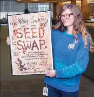  ?? WILLIAM HARVEY/RIVER VALLEY & OZARK EDITION ?? Kim Doughty, Arkansas GardenCorp­s service member, holds a sign advertisin­g the Seed Swap, a project of the Faulkner County Library and the Faulkner County Urban Farm Project, both in Conway. The annual event will be held from 1-4 p.m. Sunday at the...