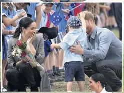  ??  ?? CHARMED Luke stole the show as 150 children turned out to greet Meghan and Harry at airport