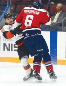  ??  ?? Lethbridge Hurricanes defenceman Ty Prefontain­e lays a hit on Medicine Hat Tigers forward Mason Shaw during Game 2 of the Eastern Conference semifinals on Saturday at the Canalta Centre.