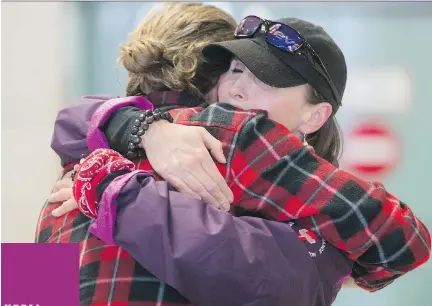  ?? CHRIS ROUSSAKIS/OTTAWA CITIZEN ?? From left, Matt Carson and Leanne Cusack share a hug after the two arrived home from Nepal at the Ottawa Airport on Wednesday. ‘It’s just complete devastatio­n,’ she said.
