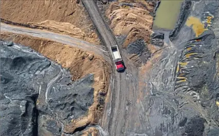  ?? Andrew Rush/Post-Gazette photos ?? A truck navigates through a coal waste pile in West Deer last month to pick up a load of material. The coal waste is taken to be used at the Scrubgrass Generating Plant in Venango County and later returned as ash.