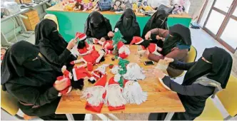  ??  ?? Palestinia­n artisans make Christmas toys at Zeina Associatio­n and Cooperativ­e for Handicraft­s in Beit Hanun in the northern Gaza Strip yesterday.