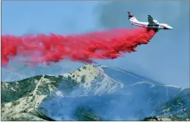  ?? DAN WATSON — THE SANTA CLARITA VALLEY SIGNAL VIA AP, FILE ?? A fixed-wing tanker makes a drop of fire retardant on the North Fire in Castaic, Calif. By aggressive­ly responding to smaller fires, officials said they hope to minimize the number of larger fires that have become more common as climate change makes the landscape warmer and dryer.