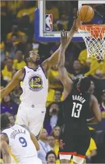  ?? JEFF CHIU/THE ASSOCIATED PRESS ?? The Warriors’ Kevin Durant blocks a shot by Rockets star James Harden in the opener of their second-round playoff series on Sunday in Oakland, Calif. The Warriors won 104-100.