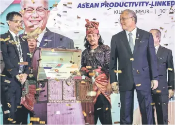  ??  ?? Riot (right) officiates at the Asean Productivi­ty-Linked Wage Conference. — Bernama photo