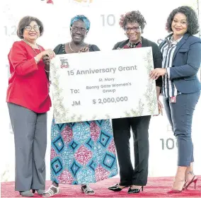  ??  ?? Shirley Vernon (second right) and Norma Nugent (second left) accept a cheque from the Digicel Foundation’s Jean Lowrie-Chin (left) and Heather Moyston.