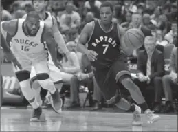  ?? MIKE MCGINNIS, GETTY IMAGES ?? Kyle Lowry of the Raptors drives to the hoop against the Milwaukee Bucks on Saturday for two of his 33 points in Toronto’s 87-76 win that evened the best-of-seven series at 2-2.