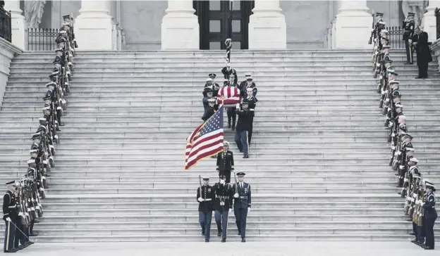  ?? PICTURE: SARAH SILBIGER ?? 0 Honour guard: Former president George HW Bush’s coffin is carried out from the US Capitol building in Washington where it had lain in state