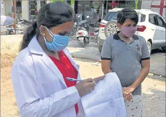  ??  ?? A health worker noting down informatio­n during Covid-19 testing , at Ashiana in Lucknow.