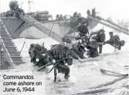  ??  ?? Commandos come ashore on June 6, 1944