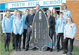  ?? Picture: PPA. ?? The pupils and their teacher with Iain Hutchison and Neil Armstrong from Merlin.