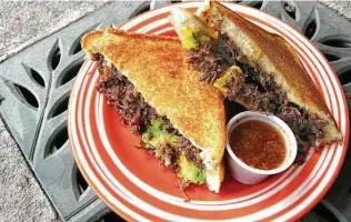  ?? Mike Sutter / Staff file photo ?? Barrio Barista gives barbacoa a contempora­ry twist, putting it in a gooey grilled cheese sandwich with avocado on Texas toast.