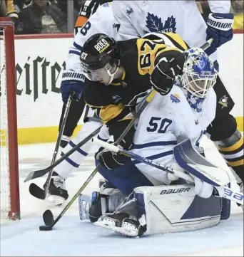  ?? Philip G. Pavely/Associated Press ?? Rickard Rakell goes over Maple Leafs goalie Erik Kallgren to score in the second period, only to have the apparent score waved off Saturday night at PPG Paints Arena.