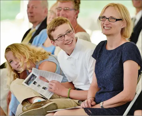  ?? SEAN D. ELLIOT/THE DAY ?? The family of U.S. Coast Guard Capt. Greg Rothrock, wife Lori and children Egan, 14 and Elly, 11, look on Monday as Rothrock assumes command of the Coast Guard Research and Developmen­t Center from Capt. Dennis Evans at Fort Trumbull State Park in New...