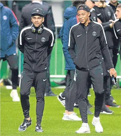  ??  ?? TAKING A STROLL: PSG’s Dani Alves, left, and Kylian Mbappe at Parkhead last night