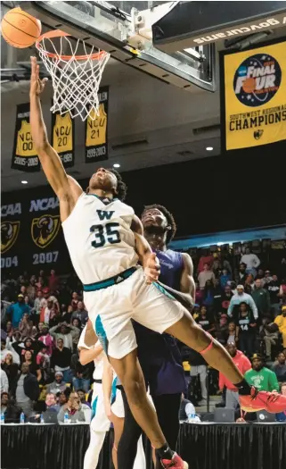  ?? BILLY SCHUERMAN/STAFF PHOTOS ?? Woodside’s Christian Greenlaw makes a reverse layup just before the buzzer for the game-winning basket in the Wolverines’ victory over Patrick Henry of Roanoke in the Class 5 state championsh­ip game Saturday at Siegel Center in Richmond.