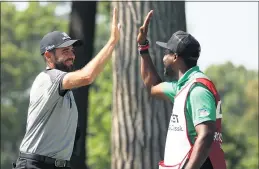  ?? GREGORY SHAMUS — GETTY IMAGES ?? Troy Merritt, left, celebrates with caddie Wayne Birch after a hole-in-one on the 11th hole in the third round of the Rocket Mortgage Classic at the Detroit Golf Club on Saturday.