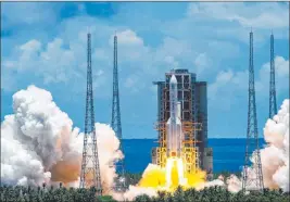  ?? The Associated Press ?? A rocket carrying the Tianwen-1 Mars probe lifts off Thursday from the Wenchang Space Launch Center in China’s Hainan province. The probe is to look for undergroun­d water.