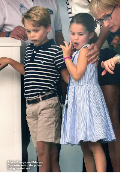  ??  ?? Prince George and Princess Charlotte watch the prizes being handed out