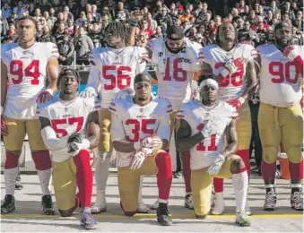  ?? ASHLEE REZIN/SUN-TIMES ?? Members of the San Francisco 49ers kneel during the national anthem before their game against the Bears at Soldier Field on Dec. 3, 2017.