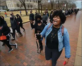  ?? (NWA Democrat-Gazette/Andy Shupe) ?? Tyrah Jackson (right) of Pine Bluff, a student at the University of Arkansas, Fayettevil­le, leads a group of students and members of the campus community on a march last month to call for the school to disassocia­te from J. William Fulbright and Charles Brough.