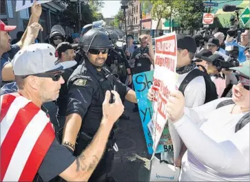  ?? Wally Skalij Los Angeles Times ?? A POLICE officer separates sides as they argue in September before right-wing provocateu­r Milo Yiannopoul­os’ speech at UC Berkeley’s famed Sproul Plaza, where the 1960s’ free speech movement began.