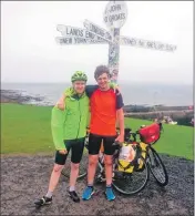  ??  ?? Chris and Jamie at the finish point at John O’Groats.