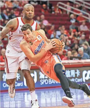  ?? TROY TAORMINA/USA TODAY SPORTS ?? Jimmer Fredette scored 41 in October in the Shanghai Sharks’ exhibition game against the Rockets and forward PJ Tucker.