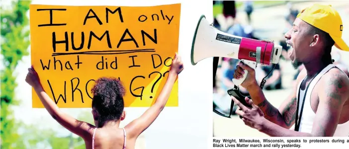  ??  ?? Rylie Blue holds a sign during a Black Lives Matter march and rally yesterday.
Ray Wright, Milwaukee, Wisconsin, speaks to protesters during a Black Lives Matter march and rally yesterday.