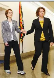  ?? — AP ?? Departing US lawmaker Gabrielle Giffords, assisted by her chief of staff Pia Carusone at Capitol Hill in Washington DC when she resigned on Jan 25, is recovering fairly well through various measures, including music therapy, after she was critically...