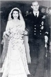  ?? AP ?? Elizabeth leaves Westminste­r Abbey in London with the Duke of Edinburgh after their wedding on Nov. 20, 1947.