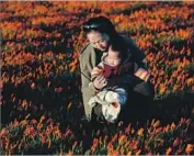  ??  ?? JOAN ONG holds Danielle Mar, 9 months, of South Pasadena, as they pose for a family photograph.