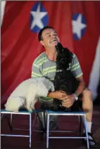  ?? NEWS-SENTINEL PHOTOGRAPH­S BY BEA AHBECK ?? Above left: A contortion­ist performs at the Ramos Bros. Circus in Lodi on June 16, 2017. Above right: Jose Vanellegas, dog trainer, with dogs Yango and King Kong at the Ramos Bros. Circus on June 16, 2017. The circus will perform at the Sacramento...