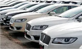  ?? [AP PHOTOS] ?? 2018 MKZ sedans sit outside a Lincoln dealership in Englewood, Colo. The Commerce Department on Monday reported U.S. retail sales rose at a healthy rate in June.