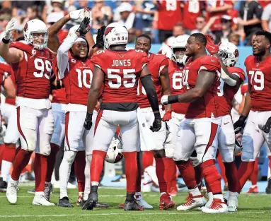  ?? CHRISTOPHE­R HANEWINCKE­L/USA TODAY SPORTS ?? Cardinals defensive end Chandler Jones (55) celebrates with teammates after one of his career-high five sacks against the Titans on Sunday at Nashville.