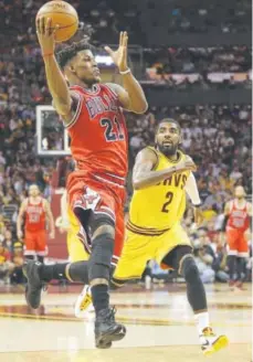  ??  ?? Chicago Bulls guard Jimmy Butler, driving against Cleveland Cavaliers guard Kyrie Irving, would be worth giving up plenty in order to acquire in a trade. Tony Dejak, The Associated Press