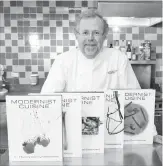  ?? STEPHEN CHERNIN THE ASSOCIATED PRESS FILE PHOTO ?? Nathan Myhrvold, author of “Modernist Cuisine: The Art and Science of Cooking,” poses with books from the work at the Institute for Culinary Education, in New York.