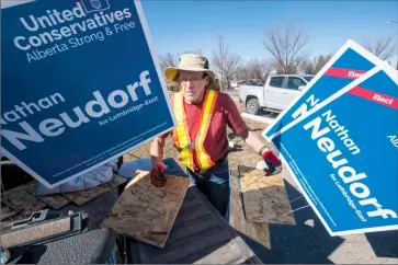  ?? Herald photo by Ian Martens ?? Roy MacLeod helps put up signs along Mayor Magrath Drive for Lethbridge-East UCP candidate Nathan Neudorf’s campaign after Tuesday’s election call, with Albertans heading to the polls April 16. @IMartensHe­rald