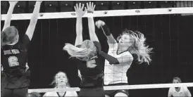  ?? Alex Eller ?? Hanna Marshall of Mullen hits the ball over the outstretch­ed hands of MaywoodHay­es Center at the State Tournament in Lincoln.