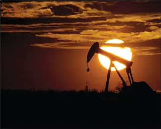  ?? THE ASSOCIATED PRESS ?? The sun sets behind an idle pump jack near Karnes City, Texas. Major oil-producing countries are deciding how much crude to pump to the world next month.